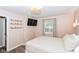 Bright bedroom with a window view, a mounted TV, and wood-look floors at 3608 Valley Lake Dr, Indianapolis, IN 46227