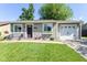 Charming single-story home with a well-manicured lawn, flowering garden and inviting front porch at 3608 Valley Lake Dr, Indianapolis, IN 46227