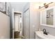 Hallway view to ensuite bathroom featuring neutral paint and white trim at 3608 Valley Lake Dr, Indianapolis, IN 46227