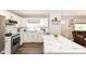 Modern kitchen featuring white cabinets, stainless steel appliances, and a stylish marble island at 3608 Valley Lake Dr, Indianapolis, IN 46227