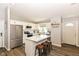 Modern kitchen featuring white cabinets, stainless steel appliances, and a stylish marble island at 3608 Valley Lake Dr, Indianapolis, IN 46227