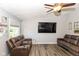 Spacious living area featuring wood-look floors, a large TV, and comfortable seating with cupholders at 3608 Valley Lake Dr, Indianapolis, IN 46227