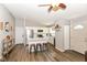 Open concept living space featuring a leather sofa, wood floors, and a stylish white kitchen at 3608 Valley Lake Dr, Indianapolis, IN 46227