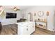 Open concept living space featuring a leather sofa, wood floors, and a stylish white kitchen at 3608 Valley Lake Dr, Indianapolis, IN 46227