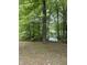 Lush backyard and mature trees creating a private and peaceful setting with a lake view at 3692 Whippoorwill Lake S Dr, Monrovia, IN 46157