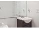 Bathroom boasts vanity, sink, mirror, lighting, and storage; toilet paper on the nearby toilet at 3937 Candle Berry Dr, Indianapolis, IN 46235