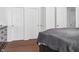 View of this carpeted bedroom with 3 white paneled doors and view of a dresser and covered bed at 3937 Candle Berry Dr, Indianapolis, IN 46235