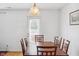Cozy dining room with wooden dining table, chairs, chandelier and a view of the door at 3937 Candle Berry Dr, Indianapolis, IN 46235