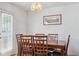 Formal dining room featuring wood table, chairs and a modern light fixture with a glass door at 3937 Candle Berry Dr, Indianapolis, IN 46235