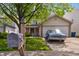 Traditional two-story home featuring a well-maintained lawn, mature trees and a blue car parked in the driveway at 3937 Candle Berry Dr, Indianapolis, IN 46235