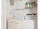 Laundry room featuring white washer and dryer with shelving and a wire rack at 3937 Candle Berry Dr, Indianapolis, IN 46235