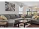 Inviting living room with a gray sectional, marble coffee table, fish tank and a leafy art piece at 3937 Candle Berry Dr, Indianapolis, IN 46235