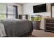 This main bedroom has a mounted television, dresser and fish tank that are a few of its amenities at 3937 Candle Berry Dr, Indianapolis, IN 46235