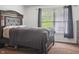 Carpeted main bedroom features a paneled headboard, window with blind and curtains and a dresser at 3937 Candle Berry Dr, Indianapolis, IN 46235