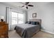 Cozy bedroom with large window offering ample natural light and a ceiling fan at 4034 Cairo Way, Avon, IN 46123