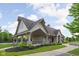 Community clubhouse exterior featuring a covered entrance, stone accents, and landscaped grounds at 4034 Cairo Way, Avon, IN 46123