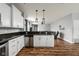 Well-appointed kitchen featuring white cabinets, granite countertops, stainless steel appliances, and hardwood floors at 4034 Cairo Way, Avon, IN 46123