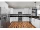Modern kitchen with stainless steel appliances, white cabinets, dark countertops and hardwood floors at 4034 Cairo Way, Avon, IN 46123
