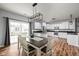 Bright eat-in kitchen features white cabinetry, modern light fixture and stainless steel appliances at 4034 Cairo Way, Avon, IN 46123