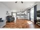 Inviting open-concept living room with hardwood floors, a breakfast bar, and a clear view into the modern kitchen at 4034 Cairo Way, Avon, IN 46123