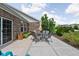 Outdoor patio with glass table, seating, and well-manicured landscaping for relaxing and entertaining at 4034 Cairo Way, Avon, IN 46123
