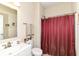 Bright bathroom with a vanity, toilet, and shower featuring a decorative red shower curtain at 4039 Amaryllis Dr, Plainfield, IN 46168