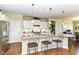 Bright kitchen with white cabinets, granite countertops, stainless steel appliances and island with bar stools at 4039 Amaryllis Dr, Plainfield, IN 46168