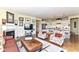 Spacious living room with a fireplace, hardwood floors, and an open layout connecting to the kitchen at 4039 Amaryllis Dr, Plainfield, IN 46168