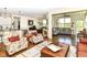 Open-concept living room showcasing hardwood floors and a seamless transition to the kitchen and dining areas at 4039 Amaryllis Dr, Plainfield, IN 46168