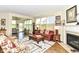 Cozy living room with a fireplace, hardwood floors, and large windows for natural light at 4039 Amaryllis Dr, Plainfield, IN 46168