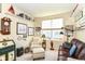 Cozy office space with a leather couch, natural light, and ample storage for books and decorative items at 4039 Amaryllis Dr, Plainfield, IN 46168
