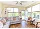 Bright sunroom with large windows, hardwood floors, and comfortable seating, perfect for relaxation at 4039 Amaryllis Dr, Plainfield, IN 46168