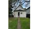 Cozy home with a small backyard and an open door leading to the interior at 41 S Warman Ave, Indianapolis, IN 46222