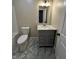 Updated bathroom features marble floors and a modern vanity at 41 S Warman Ave, Indianapolis, IN 46222