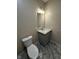 Updated bathroom features marble floors and a modern vanity at 41 S Warman Ave, Indianapolis, IN 46222