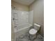 Updated bathroom features marble floors, a shower/tub and a toilet at 41 S Warman Ave, Indianapolis, IN 46222
