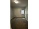 Bedroom with gray paint, carpet, window and closet, creating a simple and functional space at 41 S Warman Ave, Indianapolis, IN 46222