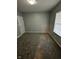 This gray painted bedroom includes a window for natural light, carpet and a closet at 41 S Warman Ave, Indianapolis, IN 46222