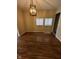 Well-lit dining area boasts elegant modern lighting and wood flooring for comfortable meals at 41 S Warman Ave, Indianapolis, IN 46222