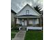 Charming two-story home with white siding, inviting front porch, and well-maintained lawn at 41 S Warman Ave, Indianapolis, IN 46222