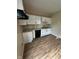 An updated kitchen features white cabinets, granite countertops, and wood grain flooring at 41 S Warman Ave, Indianapolis, IN 46222