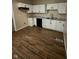 An updated kitchen features white cabinets, granite countertops, and wood grain flooring at 41 S Warman Ave, Indianapolis, IN 46222
