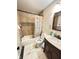 Bathroom featuring tiled walls, a decorative mirror, and vanity sink at 4144 Richelieu Rd, Indianapolis, IN 46226