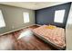 Bedroom features sleek, dark wood-look floors and natural light at 4144 Richelieu Rd, Indianapolis, IN 46226