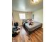 Bedroom with hardwood floors and a queen bed against an accent wall at 4144 Richelieu Rd, Indianapolis, IN 46226