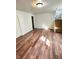 Bright living room with gleaming wood-look floors, stairs, and white trim at 4144 Richelieu Rd, Indianapolis, IN 46226