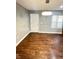 Open-concept living room featuring hardwood flooring, natural light, and a minimalist design at 4144 Richelieu Rd, Indianapolis, IN 46226