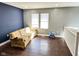 Open-concept living room featuring hardwood flooring, natural light, and a minimalist design at 4144 Richelieu Rd, Indianapolis, IN 46226
