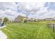 Large backyard with manicured lawn, featuring a small pond and black metal fence, perfect for recreation and relaxation at 4309 Viva Ln, Indianapolis, IN 46239