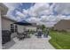 Spacious backyard patio with elegant stone work, furniture, grill, and an umbrella for relaxing and entertaining outdoors at 4309 Viva Ln, Indianapolis, IN 46239